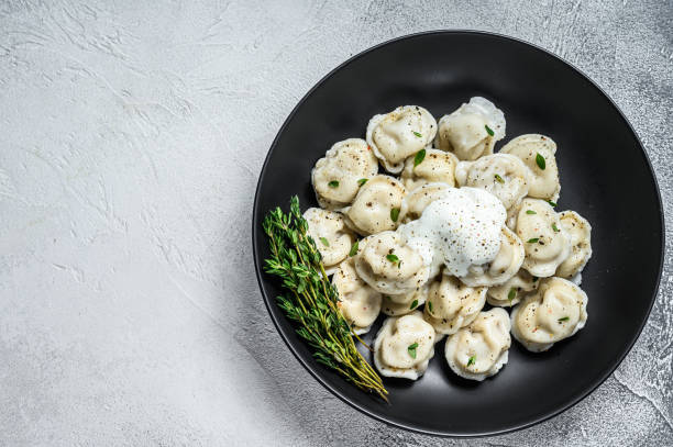 Italian ravioli dumplings with meat. White background. top view. Copy space Italian ravioli dumplings with meat. White background. top view. Copy space. russian pelmeni stock pictures, royalty-free photos & images