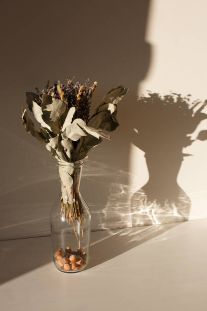 istock Interior with a glass vase filled with nuts and dried flowers 1321777281