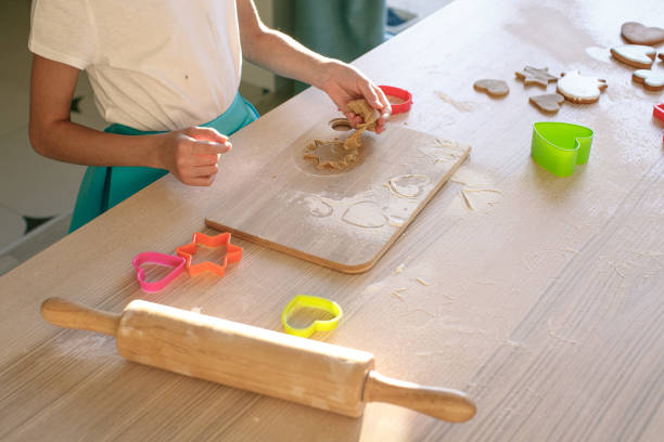 istock A mixed race girl makes cookies in the kitchen 1321777340