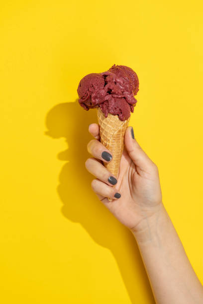 istock Hand holding mulberry icecream cone 1321777408