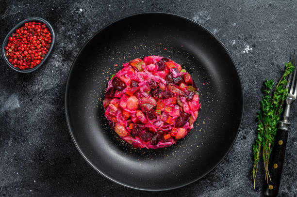 Vegetarian vinaigrette beet vegetable salad. Black background. Top view Vegetarian vinaigrette beet vegetable salad. Black background. Top view. pickled turnip stock pictures, royalty-free photos & images