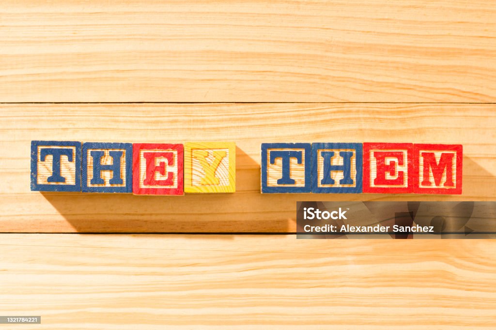 Spectacular wooden cubes with the word THEY THEM on a wooden surface. Pronoun Stock Photo