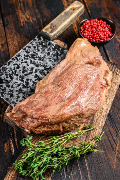 istock Marinated in mustard Marinate beef tri tip steak for bbq. Black background. Top view 1321784448