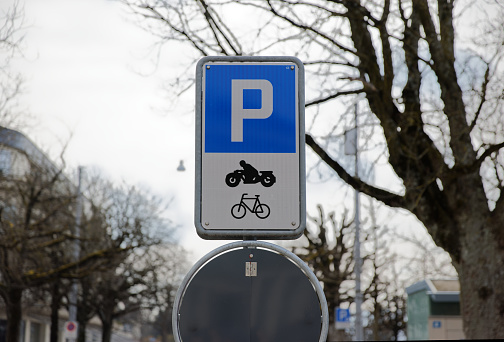 blue white parking sign, parking for motorcycles is allowed here during the day without people