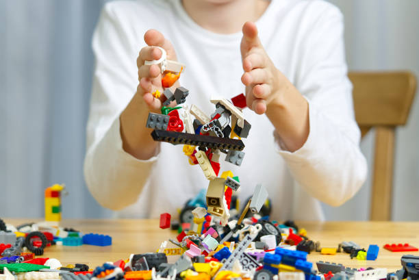 istock Close up of child's hands playing with colorful plastic bricks at the table. development of fine motor skills in children, favorable for the development of brain activity. Developing toys 1321790843