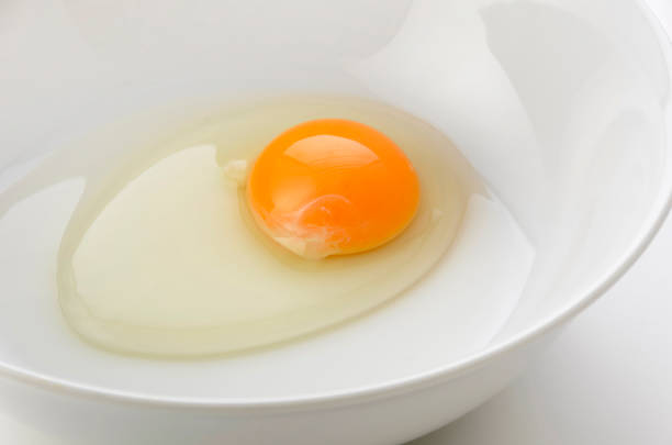 istock yellow egg yolks in a white bowl 1321791963