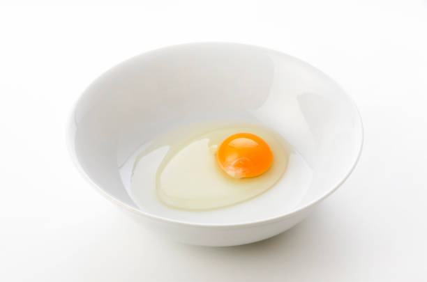istock yellow egg yolks in a white bowl 1321792032