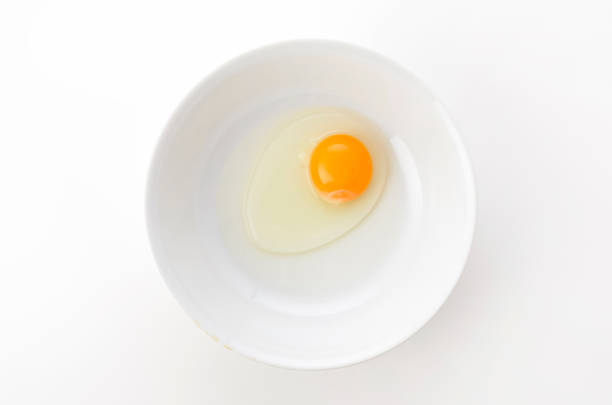 istock yellow egg yolks in a white bowl 1321792150