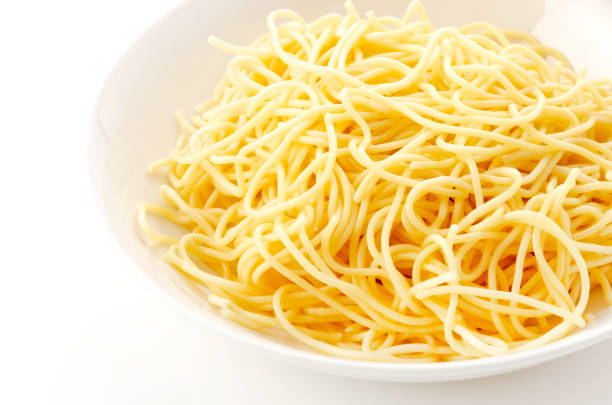 istock Spaghetti Noodles in Plate on White Background 1321792722