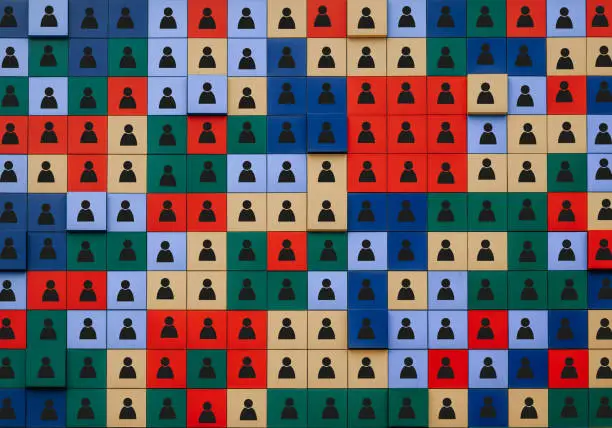 Photo of concept of diversity. A large number of colored cubes with icons depicting people.