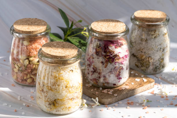 Spa and Wellness Floral and Herbal Natural Bath Salts floral bath salt for relaxation, wellness, and body care. Spa and aromatherapy experience bath salt photos stock pictures, royalty-free photos & images
