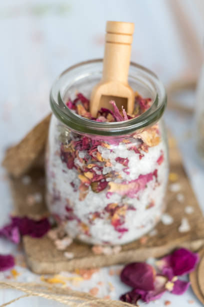 Spa and Wellness Floral and Herbal Natural Bath Salts floral bath salt for relaxation, wellness, and body care. Spa and aromatherapy experience bath salt stock pictures, royalty-free photos & images