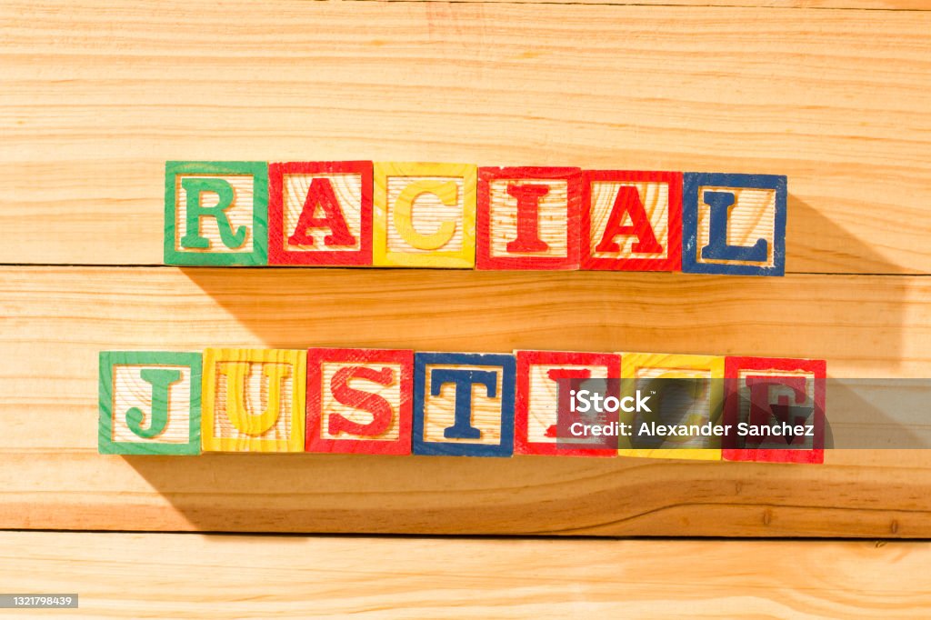 Spectacular wooden cubes with the word RACIAL JUSTICE on a wooden surface. Civilian Stock Photo