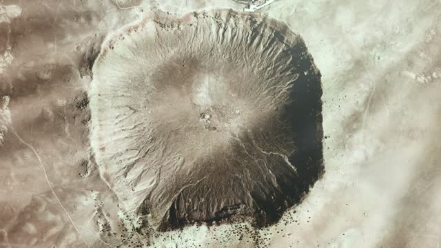 Meteor Crater, also known as Barringer Crater, in the northern Arizona desert of the United States, Seen from Space. Elements of this video furnished by NASA.