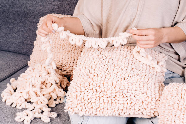 istock Knits made from thick soft yarn. Soft knitted cushions made of thick yarn. 1321814630