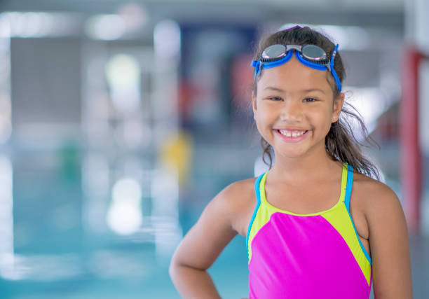 istock Smiling girl at the pool 1321814775