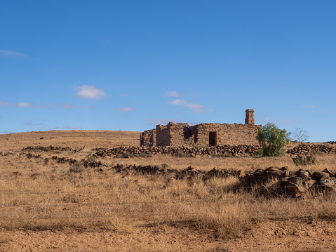 Ruins of stone farm building in Flat Arid Country