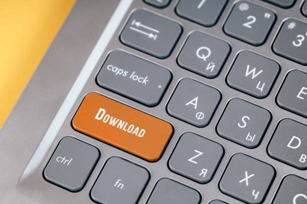 istock Orange boot key on a gray keyboard close-up. Button for downloading data from the Internet 1321822799