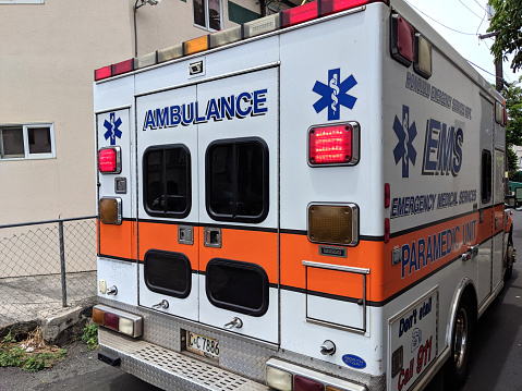 Honolulu - May 25, 2018: Emergency Medical Services Paramedic Unit Ambulance parked on small lane.