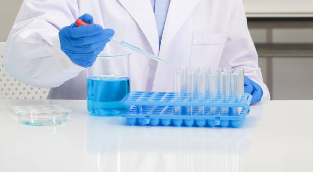 istock Scientist in blue shirt and lab coat do experiments in a scientific laboratory. Soft focus use for background. 1321826600