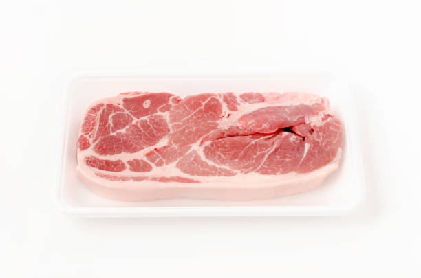 istock Raw pork meat in foam tray on white background 1321830418