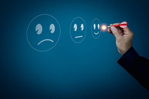 istock Businessman darts a smiley face emoticon on virtual touch screen. Customer service evaluation concept. 1321833823
