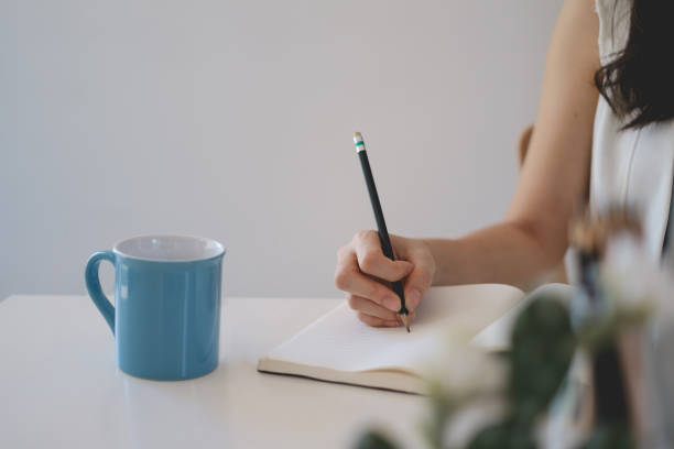 istock Young female college taking notes and using highlighter. Focused student in online class room. Authentic Education concept. 1321835488
