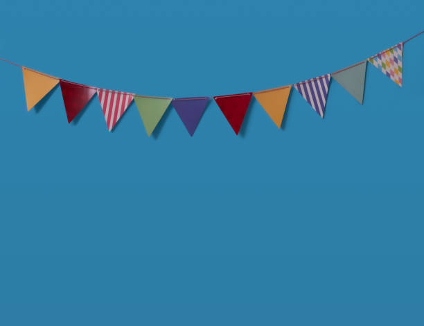 istock Paper party flags for decoration and covering on blue background. 1321838331