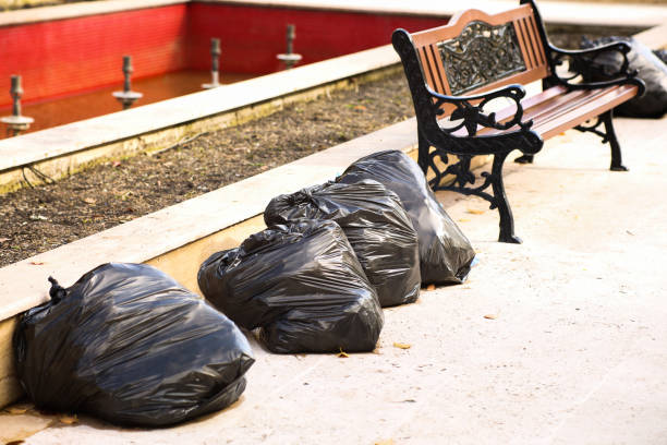 istock Black plastic garbage bags on the sidewalk. 1321839415