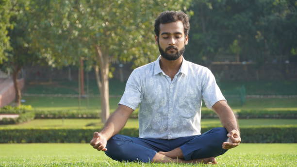 istock man doing meditation in park in office hours 1321842938