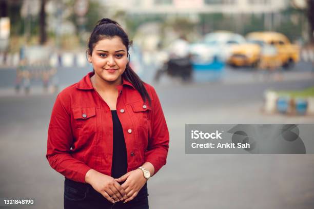 Portrait Of Young Brunette Asian Indian Girl Wearing Red Denim Shirt And  Smiling Stock Photo - Download Image Now - iStock