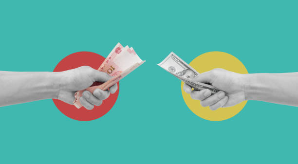 istock Digital collage modern art. Hand holding Yuan and US Dollar banknotes 1321849564