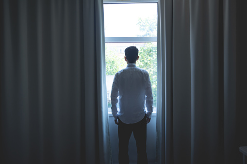 Young man looking out of window