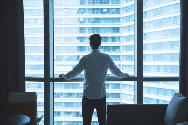 istock Businessman looking through window in office 1321851000