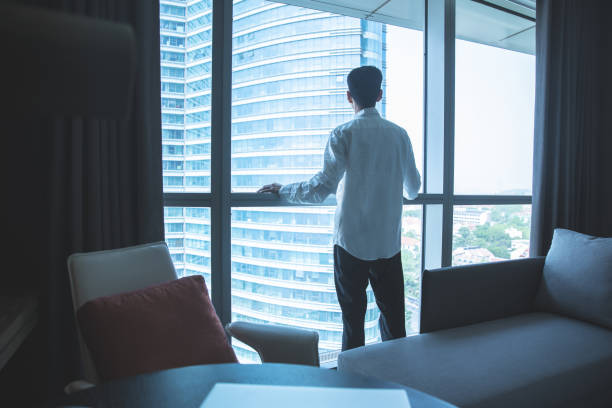 istock Businessman looking through window in office 1321851025