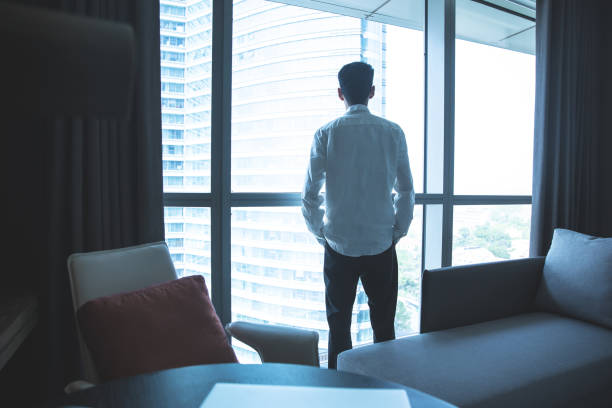 istock Businessman looking through window in office 1321851032