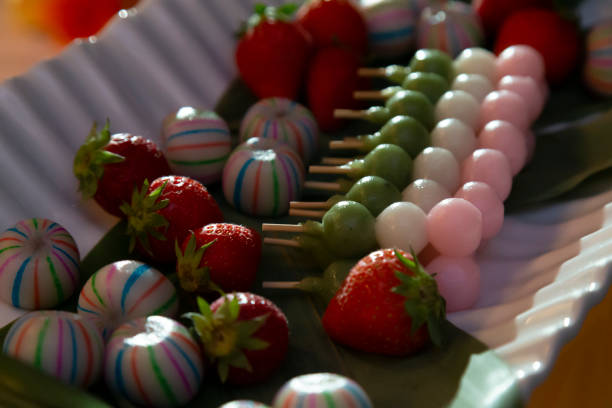 Put dumplings and strawberries on a plate Bamboo leaves, Japanese sweets and strawberries are lined up on the plate. red bean dessert stock pictures, royalty-free photos & images