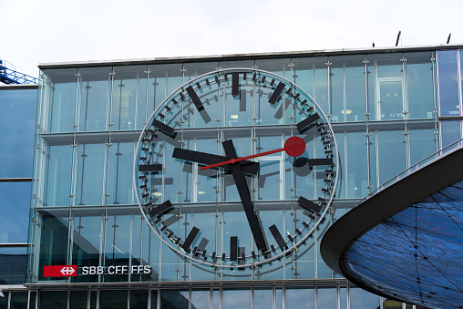 Big clock at modern glass facade of Aarau main railway station. Photo taken June 4th, 2021, Aarau, Switzerland.