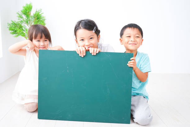 enfants tenant un tableau noir de message - presentation poster student classroom photos et images de collection