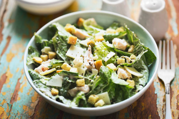istock Chicken Caesar salad with parmesan and croutons 1321857973