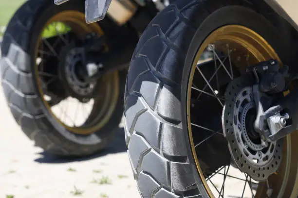 Two rear wheels of a motorcycle with brake discs. main criteria for choosing the right tires for a motorbike