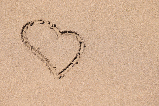 drawing a heart shape on the sand in the morning. love and emotions To welcome the Valentine's Day festival