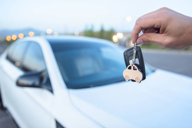 istock man holding key with car 1321860943