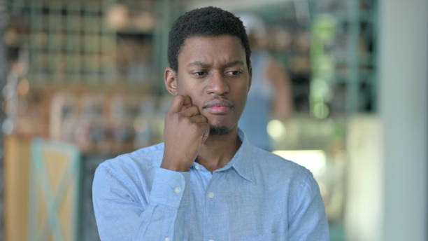 istock Portrait of Thoughtful Young African Man Thinking and getting Idea 1321863814