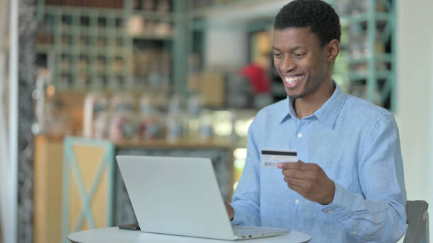 istock Successful Online Payment on Laptop by Young African Man 1321864286