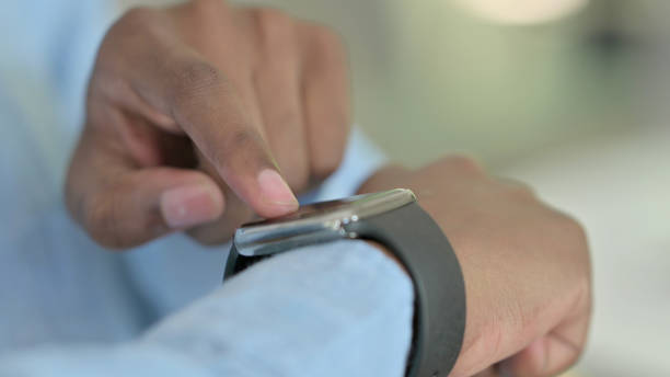istock Close up of Serious Young African Man using Smartwatch 1321864858