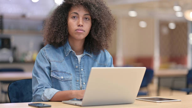 istock African Woman with Laptop Looking at Camera at Work 1321866731