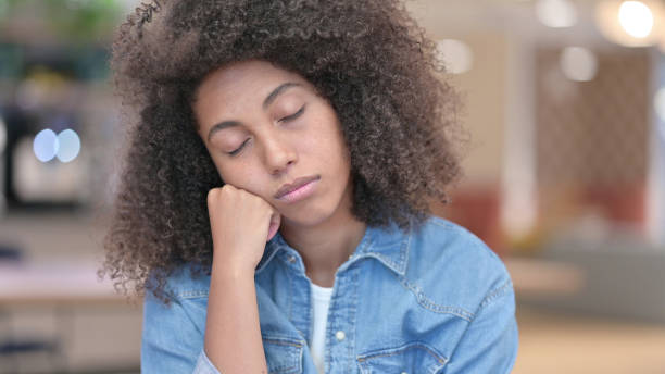istock Portrait of African Woman Sleeping at Work 1321867304