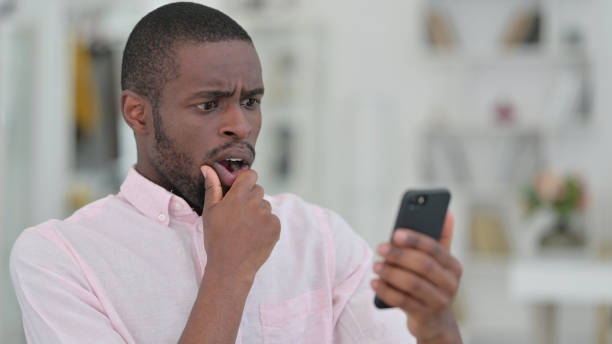 istock Portrait of African Man Upset by Failure on Smartphone, Failure 1321867607