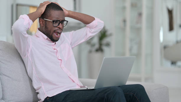 istock Failure, African Man having Loss on Laptop at Home 1321868477